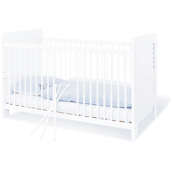 Weißes Babybett mit blauer Matratze